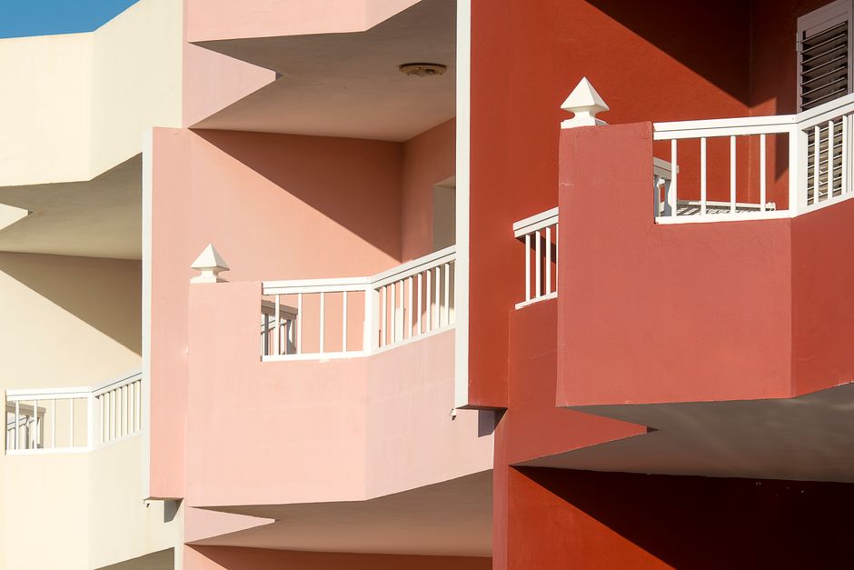 Building front with painted balconies.